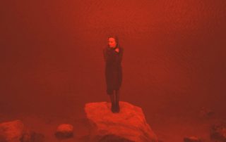 Red tinted image of financially desperate woman standing at water's edge